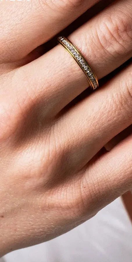 Quiet Ring worn on a hand, close up